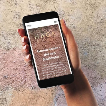 Italienska restaurangen Haga Bottegas webbplats i mobil mot sten